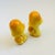 A pair of vintage ceramic salt and pepper shakers in the shape of mushrooms, each with a removable plastic stopper....