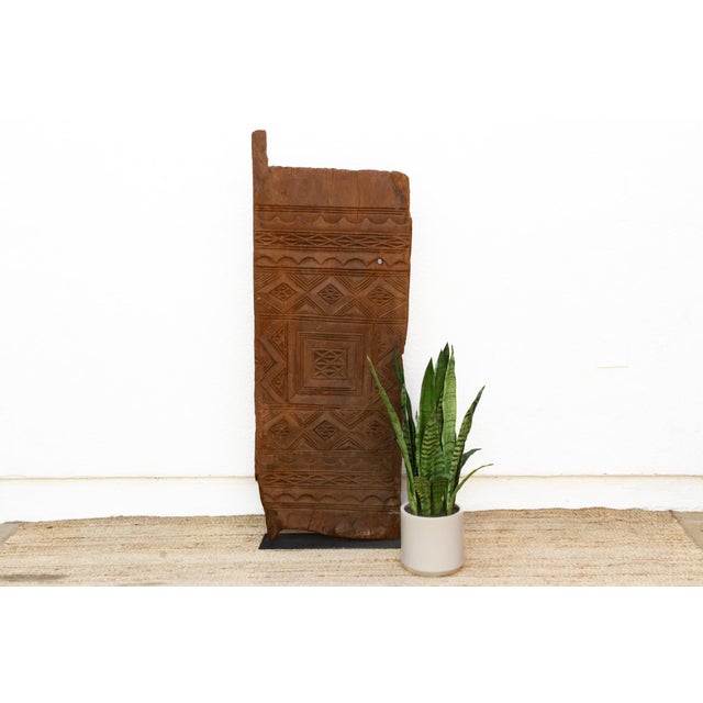 Hand-carved from a single length of hardwood, this door showcases one of the more intricate expressions of Mali's Dogon...