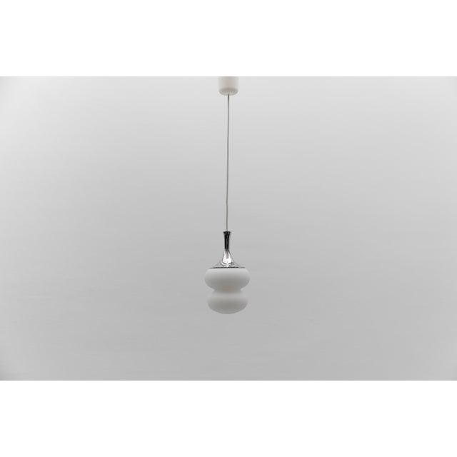 Lovely petit space age opal glass hanging lamp with chrome, 1960s germany executed in opaline glas and chrome. the lamp...