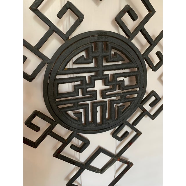 Unusual and large iron wall hanging with three pads for candles, potted plants, or objet d'art such as small figurines....