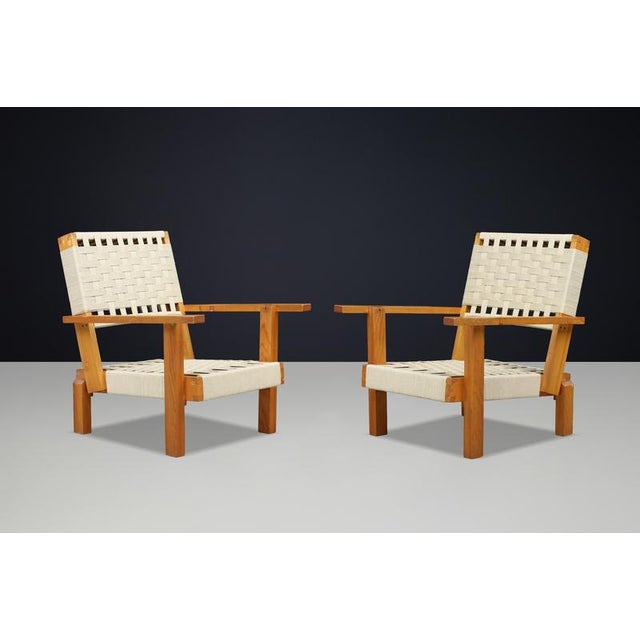 An exceptional pair of Italian lounge chairs handcrafted from solid pine during the 1970s. Defined by their sculptural...