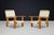 An exceptional pair of Italian lounge chairs handcrafted from solid pine during the 1970s. Defined by their sculptural...