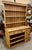 Antique English Pine. Two piece stepback cupboard. The base has open shelving in addition to a bank of 12 drawers. All...