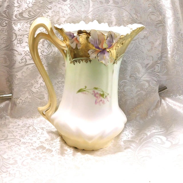 This is an unmarked chocolate pot with great shaping on the top rim and around the bottom with a split handle and gold...