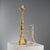 Carved and gilded wooden candelabra, featuring a turned central body that expresses the elegance and refinement typical of...