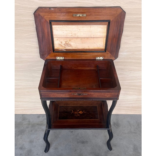 Antique Napoleon III sewing table, circa 1880 The marquetry is made of various woods. A brass feast surrounds the table...