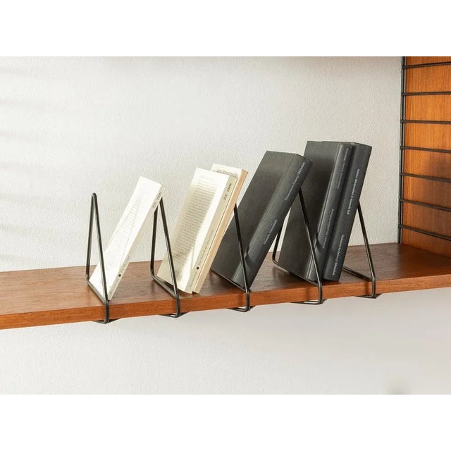 Original string book holder designed in 1949 by nils strinning made of black lacquered metal. Set of 5. Made in sweden....