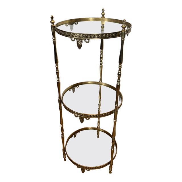 1940s Round brass pedestal table with three glass shelves. French work Attributed to Maison Jansen For Sale