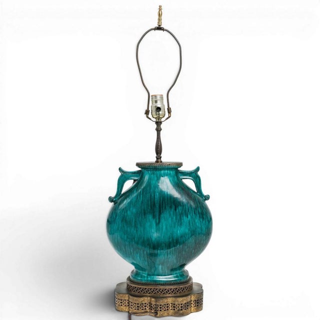 A 1940's Italian Modern green ceramic Chinese-style table lamp by produced in Italy by Marcello Fantoni for Raymor. The...