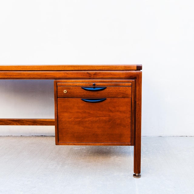 Walnut and rosewood executive desk with sculpted drawer pulls by Jens Risom, made in the US in the 1960s. Similar to...