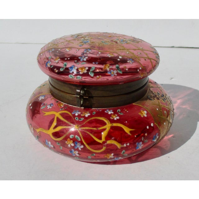 Lovely Cranberry Glass by Moser circa 1900. Brass mounted and designed with fields of tiny flowers in enamel with a...