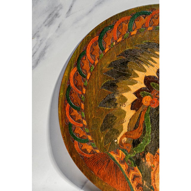 A striking example of turn-of-the-century folk art craftsmanship, this circa 1900 hand-painted pyrography wood wall plaque...