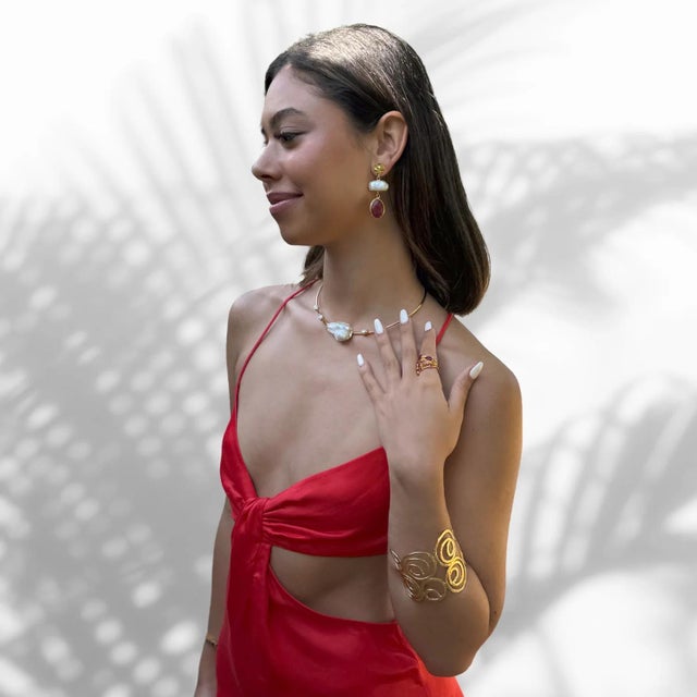 Discover the epitome of elegance with the Majestic Pearl & Gold Choker Necklace. This stunning piece is a perfect blend of...