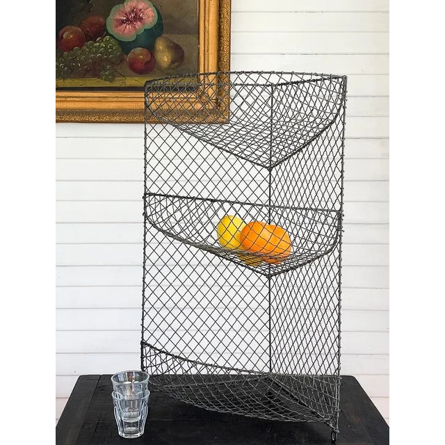 Beautiful Edwardian wire stand, sourced in England. Its triangular, three-tier design makes a striking display from any...