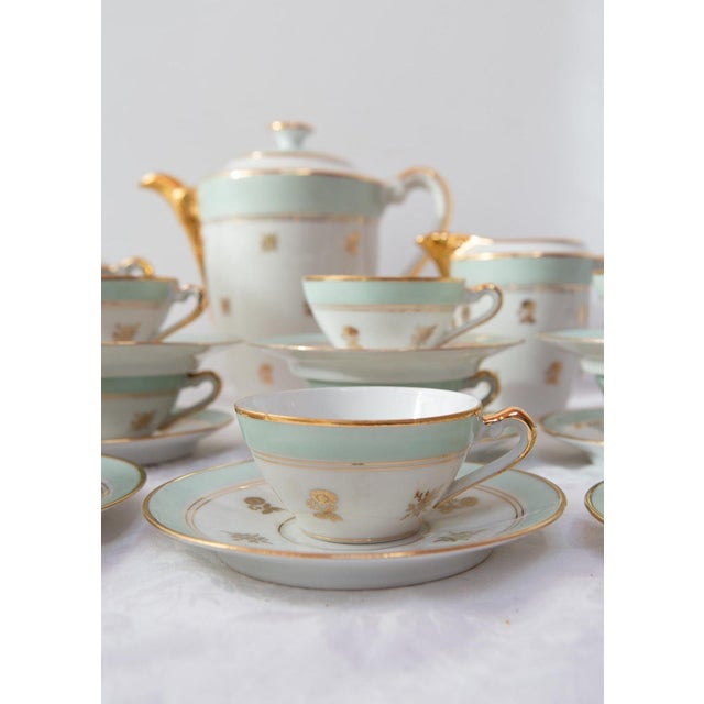 Tea or coffee set for 12 in French Limoges porcelain from around the 1950s, with a green band, gold rims and small gold...