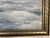 A large, atmospheric oil painting portraying a quiet, wintry countryside—snow-blanketed fields stretch toward gently...