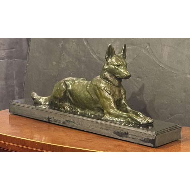 A fine French sculptural figure of an Alsatian dog of patinated bronze - from the Belle Epoque period - set upon a...