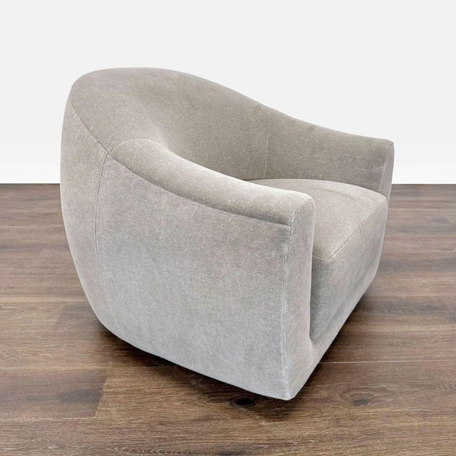 This Maiden Home swivel lounge chair features a sleek, rounded design with soft limestone fabric. Its wide seat and plush...