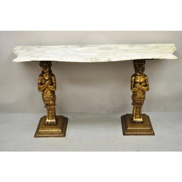 Vintage French Renaissance Victorian Style Gold Figural Marble Top Console Table. Item features a shaped marble top,...