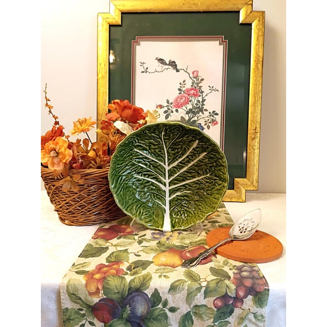 This vintage Bordallo Pinheiro cabbage salad bowl features a rich, multi-tonal green glaze over an intricately molded leaf...