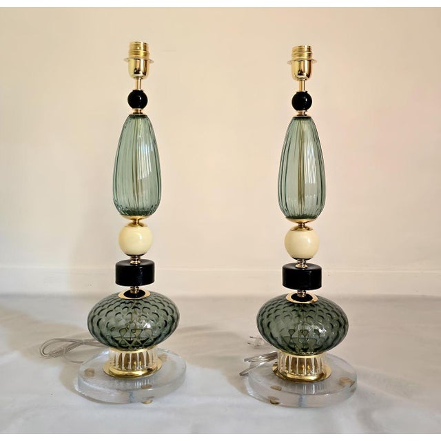 Pair of Mid-Century Modern Murano glass table lamps, Italy circa 1980s. The Italian lamps are made of various elements in...