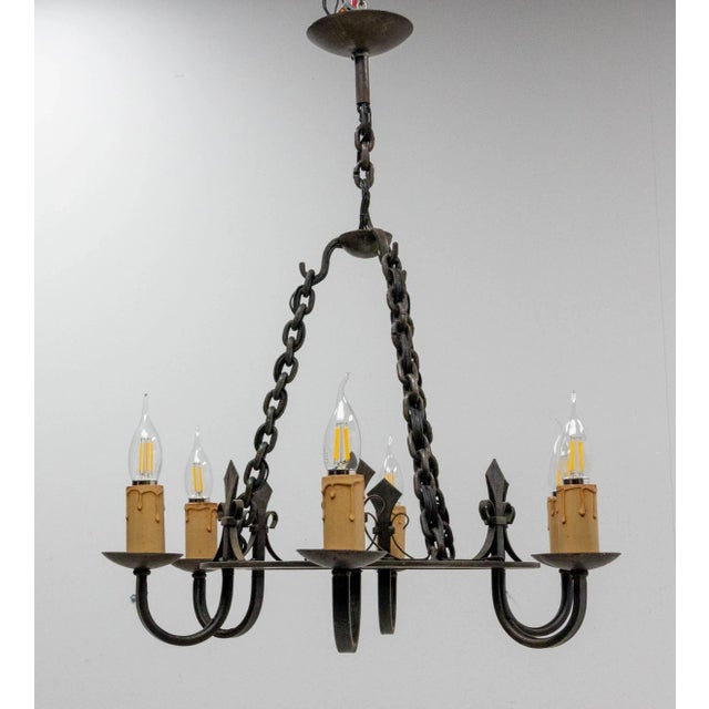 Chandelier, French Wrought iron with fleur-de-lys Mid-century Good vintage condition. European Plug (up to 250V).The...