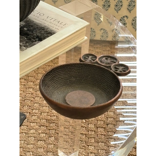 Nicely cast copper vide poche with three asymmetrical circular protrusions, each with a primitive art motif; a bird and...