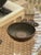 Nicely cast copper vide poche with three asymmetrical circular protrusions, each with a primitive art motif; a bird and...