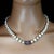 This beautiful 19‑inch necklace features double‑shine white pearls measuring approximately 9x7mm, each one offering a soft...