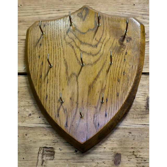 Oak Shield Hotel Reception Key Board This is a Solid Oak Key board in the shape of a shield, it has 10 key hooks on the...