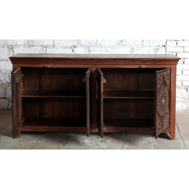 This antique carved sideboard showcases timeless craftsmanship with its intricate lotus motifs and beautifully aged two-...