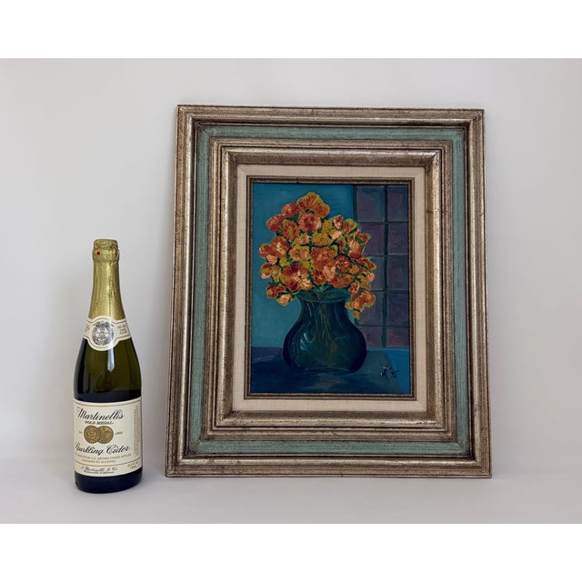 Original oil painting of floral still life featuring orange, yellow, and coral blossoms in a deep green vase against a...