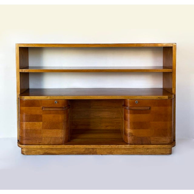 A distinctive 1930s italian art deco bookcase, entirely veneered in walnut. it features a simple, regular, and symmetrical...