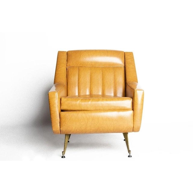 This vintage vinyl armchair is a design furniture produced in Italy in the 1950s. Imitation leather armchair with legs in...