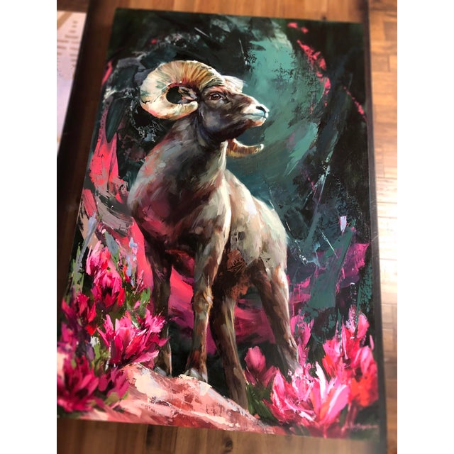 This oil painting captures the majestic Rocky Mountain Bighorn Sheep, poised gracefully against a dramatic backdrop of...