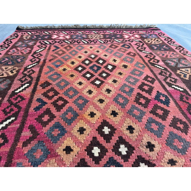 This vibrant Afghan handmade kilim rug, measuring 3'4"x6'2", features a striking flat weave design with bold tribal...