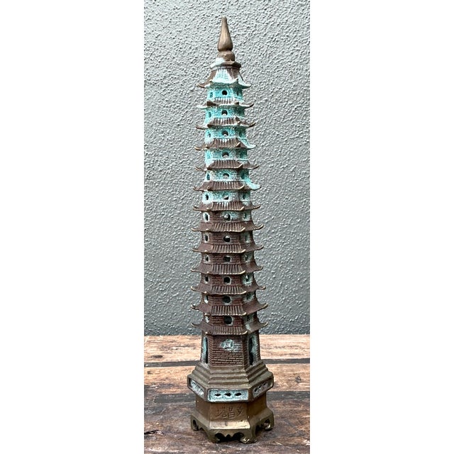 This elegant nine-tier pagoda sculpture is a masterful example of vintage Chinoiserie design, blending architectural...