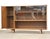 A mid century modern walnut bookcase with glass sliding doors and a push to open diamond front door. Original finish. 66”...