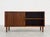 Mid Century Modern Danish rosewood sideboard featuring a tambour door and open shelving, c. 1960’s. This piece offers a...