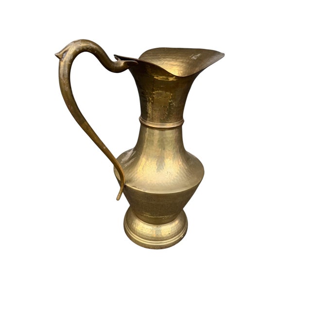 A beautiful vintage Middle Eastern brass pitcher, crafted in heavy, hand‑hammered brass with a warm, rich patina. This...