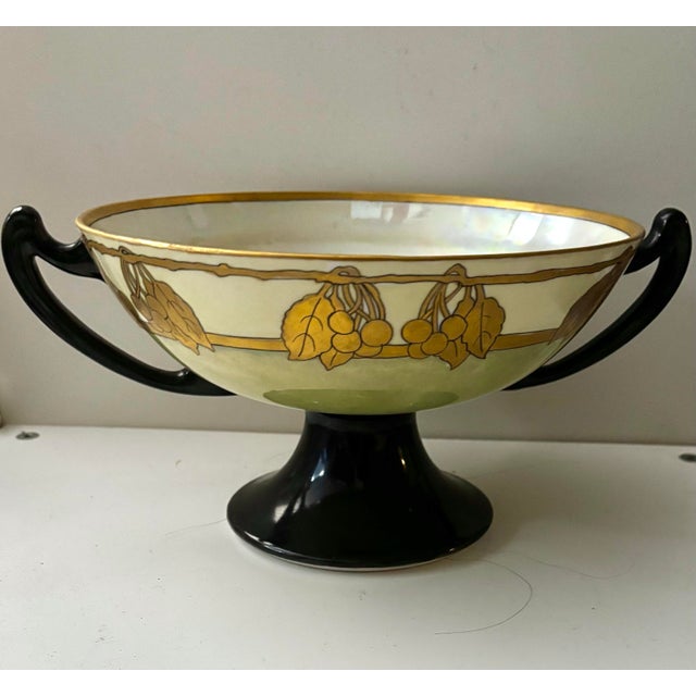 An elegant turn-of-the-century porcelain centerpiece bowl, hand painted and signed C. M. Button. Dating to approximately...