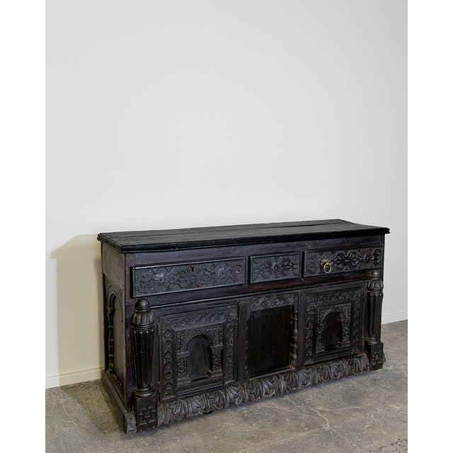 This striking antique buffet or credenza showcases bold Renaissance-inspired craftsmanship, likely of Spanish or Spanish...