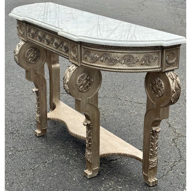 Absolutely stunning console table by Amy Howard. This robustly carved console features four legs with claw feet, beveled...