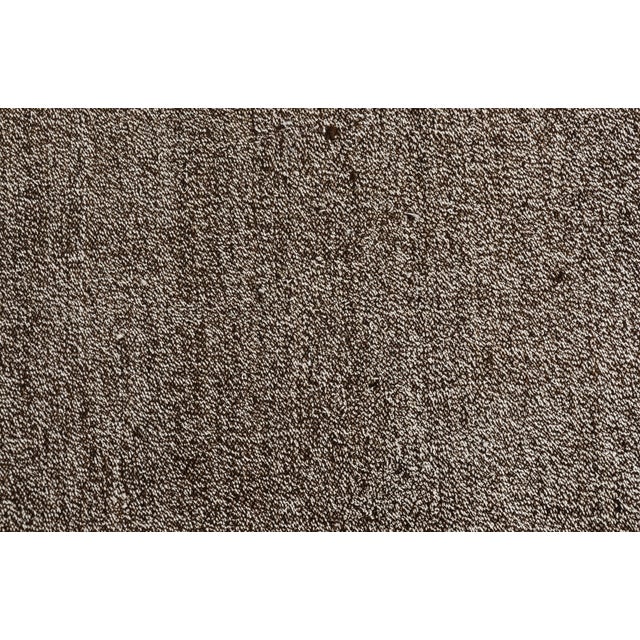 This is a vintage Turkish Oushak rug from the Mid 20th Century. The piece was hand-knotted.