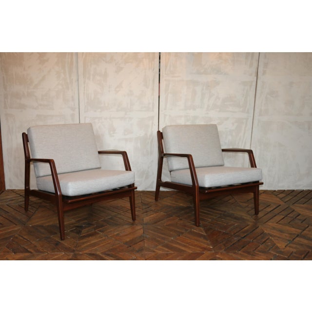 A stunning pair of sculptural lounge chairs designed by Danish master Ib Kofod-Larsen, Denmark, circa 1950s. These chairs...