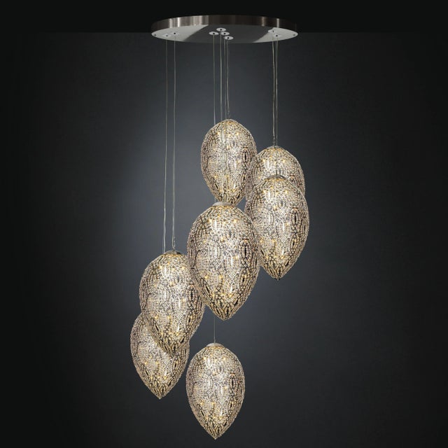 This chandelier features 7 lamps. It works with G9 led bulbs and has a silver finish. Up to 250V (Europe/UK Standard).