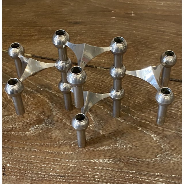 A beautiful set of four nagel candlesticks that can be stacked and arranged as desired. these pieces are made of chrome-...