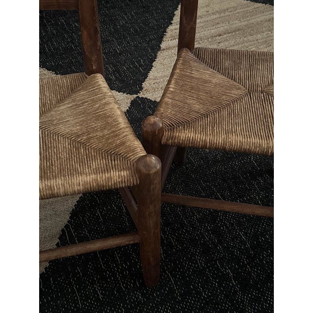 Handcrafted oak and woven rush chairs from Northern Michigan, echoing the frontier furniture of the Upper Peninsula with...