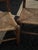 Handcrafted oak and woven rush chairs from Northern Michigan, echoing the frontier furniture of the Upper Peninsula with...