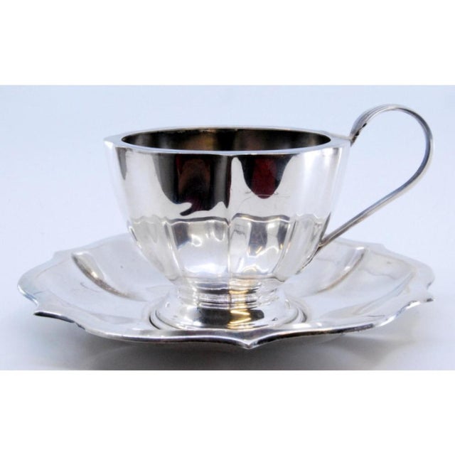 Cup and Saucer in Silver with Ribs and Curved Handle, Set of 2, in Very Good conditions. Designed 1960 to 1969 This piece...